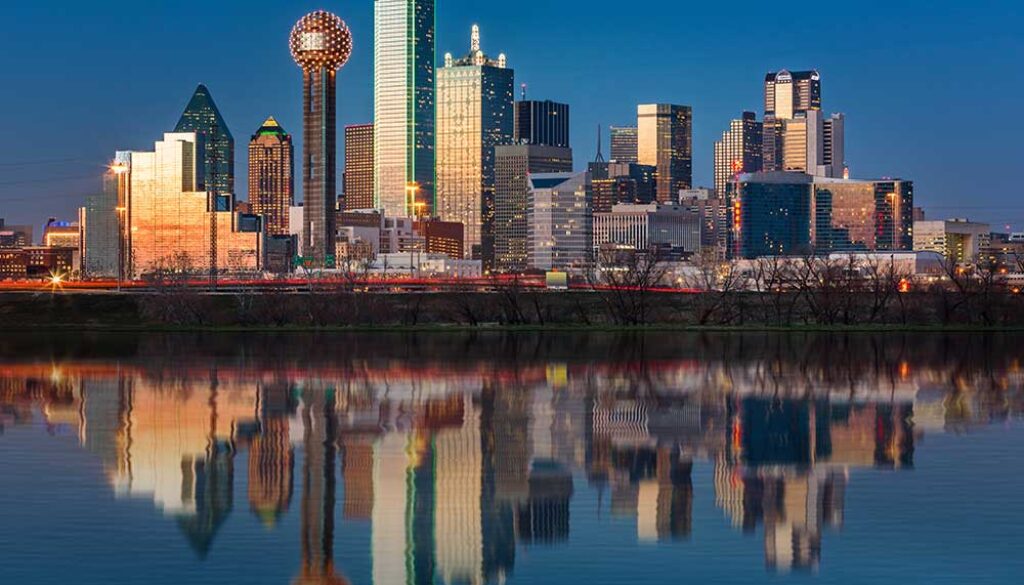 The classic Dallas, Texas skyline at dusk, with reflections in the Trinity River